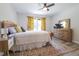Comfortable bedroom with natural light, complemented by a vibrant rug and matching decorative curtains at 420 E Grandview Ave, Liberty, NC 27298