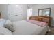 Bright bedroom features wood-look floors, a bed, closet doors, and a dresser with mirror at 420 E Grandview Ave, Liberty, NC 27298