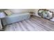 Bright bedroom features wood-look floors, a twin bed, a window, and a gold mirror at 420 E Grandview Ave, Liberty, NC 27298