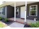 Charming front porch featuring white columns and lush landscaping at 420 E Grandview Ave, Liberty, NC 27298