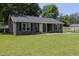 Well-maintained single-story home with a lush green lawn, beautiful siding, and manicured shrubbery at 420 E Grandview Ave, Liberty, NC 27298