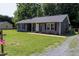 Beautiful single-story home with well-kept lawn, gray siding, and gravel driveway at 420 E Grandview Ave, Liberty, NC 27298