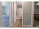 Hallway view with wood-look floors leading to a bedroom and bathroom at 420 E Grandview Ave, Liberty, NC 27298