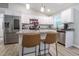 Stylish kitchen featuring granite counters, white cabinets, stainless appliances, and seating area at 420 E Grandview Ave, Liberty, NC 27298
