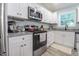 Beautifully updated kitchen featuring white cabinets, granite counters, and stainless steel appliances at 420 E Grandview Ave, Liberty, NC 27298
