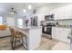 Open kitchen with granite counters, white cabinets, stainless appliances, and bar seating at 420 E Grandview Ave, Liberty, NC 27298