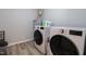 Functional laundry room equipped with modern washer and dryer units, and storage space at 420 E Grandview Ave, Liberty, NC 27298