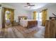 Bright and airy main bedroom with wood flooring, ceiling fan, and natural light at 420 E Grandview Ave, Liberty, NC 27298