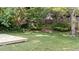 Private backyard oasis features lush landscaping, mature trees, and a tranquil seating area at 4213 Stoneford Trace Dr, Raleigh, NC 27616