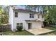 View of a white siding home with a new wooden deck and backyard, featuring a sliding glass door at 4213 Stoneford Trace Dr, Raleigh, NC 27616