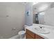 Bathroom with neutral walls, sink, toilet, mirror and blue art on the wall at 4213 Stoneford Trace Dr, Raleigh, NC 27616
