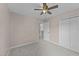 Bedroom with neutral walls, carpet, ceiling fan and a double door closet at 4213 Stoneford Trace Dr, Raleigh, NC 27616