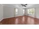 This bedroom has hardwood floors, with a ceiling fan, and multiple windows for great natural light at 4213 Stoneford Trace Dr, Raleigh, NC 27616