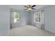 Bright bedroom with neutral walls, carpet, and two windows with curtains at 4213 Stoneford Trace Dr, Raleigh, NC 27616