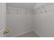 Walk-in closet with white walls, neutral carpet, and built-in shelving for storage at 4213 Stoneford Trace Dr, Raleigh, NC 27616