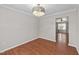 Bright and airy dining room featuring hardwood floors, a chandelier, and views of the yard at 4213 Stoneford Trace Dr, Raleigh, NC 27616