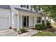 A close-up of the front entrance shows the pillars and plants that surround the porch at 4213 Stoneford Trace Dr, Raleigh, NC 27616