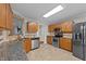 Bright kitchen with stainless steel appliances, granite countertops, mosaic tile backsplash and wood cabinetry at 4213 Stoneford Trace Dr, Raleigh, NC 27616