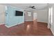 Open-concept living area with durable flooring, a ceiling fan, and a wall-mounted television at 4213 Stoneford Trace Dr, Raleigh, NC 27616