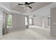 Large bedroom with carpet, ceiling fans, neutral walls, double door closets, and three large windows at 4213 Stoneford Trace Dr, Raleigh, NC 27616