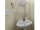A clean powder room with a pedestal sink, faucet, and a round mirror on the wall at 4213 Stoneford Trace Dr, Raleigh, NC 27616