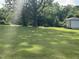 Expansive backyard with mature trees and detached garage at 45 Perkinson St, Kittrell, NC 27544