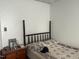 Simple bedroom design featuring dark wood accents, a queen-sized bed, and a quaint nightstand setup, perfect for resting at 45 Perkinson St, Kittrell, NC 27544