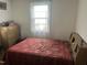 Simple bedroom with a bed, dresser, and window, offering a comfortable space at 45 Perkinson St, Kittrell, NC 27544