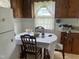 Cozy kitchen with wooden cabinets, table with chairs, and natural light from the window at 45 Perkinson St, Kittrell, NC 27544