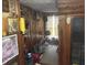 Wood-paneled room filled with personal items, collectibles, and a unique assortment of decor, creating an eccentric vibe at 45 Perkinson St, Kittrell, NC 27544