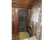 Charming wood-paneled room with window and decorative curtains at 45 Perkinson St, Kittrell, NC 27544