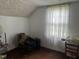 Simple room with hardwood floors, textured ceiling, window, and furniture at 45 Perkinson St, Kittrell, NC 27544