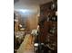 Unique wood-paneled room with shelving, a bed, and decorative items at 45 Perkinson St, Kittrell, NC 27544