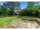 Backyard with mature landscaping and patio area at 5006 Silhouette Dr, Durham, NC 27713
