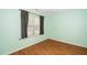 Clean bedroom with a window providing natural light, and hardwood floors at 5006 Silhouette Dr, Durham, NC 27713