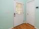 Interior entryway featuring a white door with glass panels and wood flooring at 5006 Silhouette Dr, Durham, NC 27713