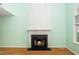 A cozy living room features a fireplace with white mantle, creating a focal point at 5006 Silhouette Dr, Durham, NC 27713