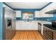 Featuring white cabinets, wood floor and stainless steel appliances at 5006 Silhouette Dr, Durham, NC 27713