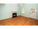 Living room showcasing a fireplace, hardwood floors, and a view of the backyard at 5006 Silhouette Dr, Durham, NC 27713