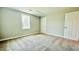 A bright bedroom with neutral walls, carpet flooring, and white trim at 505 E Canary St, Dunn, NC 28334