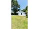 Charming single-story home with white siding nestled among mature trees at 505 E Canary St, Dunn, NC 28334