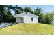 Charming single-story home with white siding, manicured lawn, and mature trees at 505 E Canary St, Dunn, NC 28334