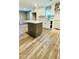 Modern kitchen with island, white cabinets, and stainless steel hood for a contemporary feel at 505 E Canary St, Dunn, NC 28334