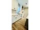 Close up of modern kitchen sink and counter featuring white cabinetry, and luxury vinyl flooring at 505 E Canary St, Dunn, NC 28334