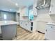 Modern kitchen featuring white cabinets, a gray island, stainless steel appliances, and stylish backsplash at 505 E Canary St, Dunn, NC 28334