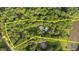 Expansive aerial view of the property highlighting the estate, pool, and surrounding trees at 5344 Mill Dam Rd, Wake Forest, NC 27587