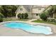 Backyard with an in-ground pool, concrete surround, mature trees, and white picket fence at 5344 Mill Dam Rd, Wake Forest, NC 27587