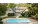 Backyard featuring a large in-ground pool with an elegant home in the background at 5344 Mill Dam Rd, Wake Forest, NC 27587