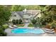 Staged backyard with a large in-ground pool, lounge chairs, and dining area at 5344 Mill Dam Rd, Wake Forest, NC 27587