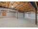 Spacious unfinished basement with concrete floors, wood beams and painted cinder block walls at 5344 Mill Dam Rd, Wake Forest, NC 27587